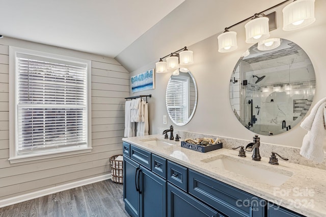 bathroom featuring wood walls, a shower with door, wood-type flooring, and vaulted ceiling