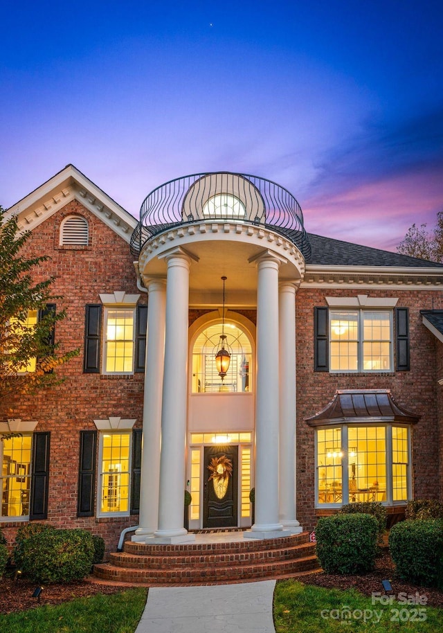 view of front of house featuring a balcony