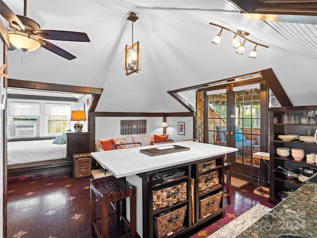 dining area featuring dark wood-type flooring, french doors, a healthy amount of sunlight, and lofted ceiling