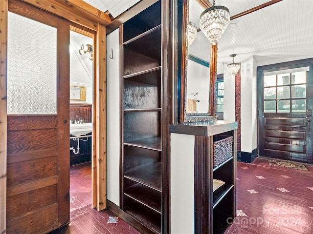 hallway featuring dark hardwood / wood-style flooring, a notable chandelier, and wood ceiling