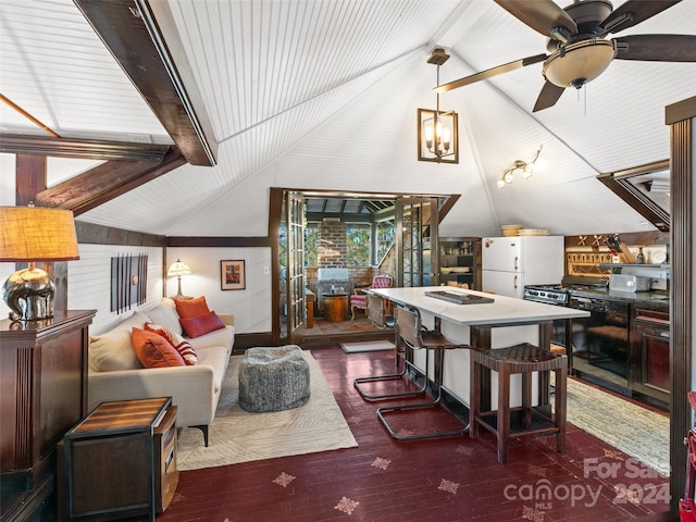 dining room featuring ceiling fan, dark wood-type flooring, and vaulted ceiling