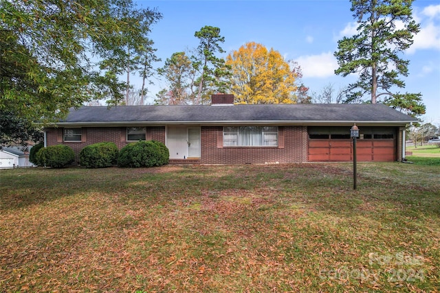 ranch-style house featuring a front lawn and a garage