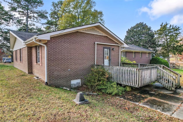 exterior space featuring a deck and a front lawn