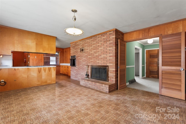 unfurnished living room featuring wood walls, a fireplace, and ornamental molding