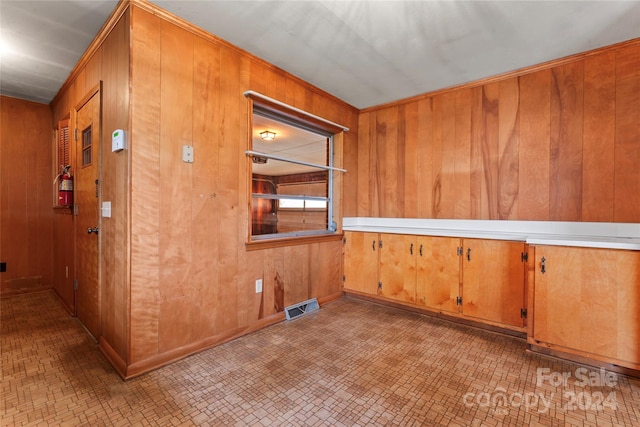 empty room featuring wood walls