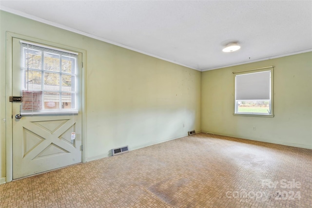 empty room featuring ornamental molding