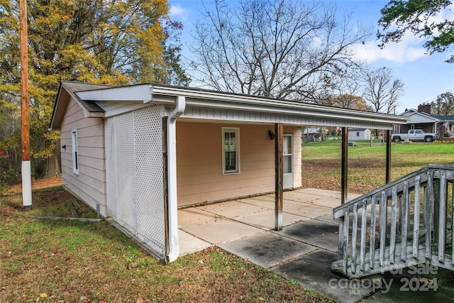 view of outbuilding featuring a yard and a carport