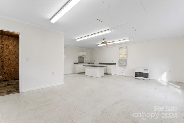 interior space featuring ceiling fan and crown molding