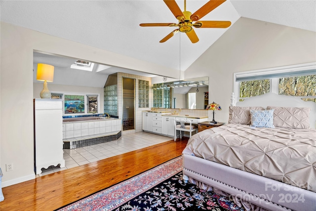 bedroom with high vaulted ceiling, light hardwood / wood-style flooring, and ceiling fan