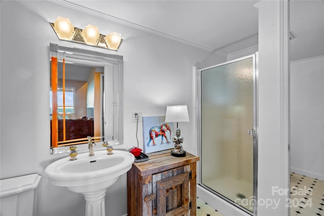 bathroom featuring a shower with door, tile patterned flooring, and sink