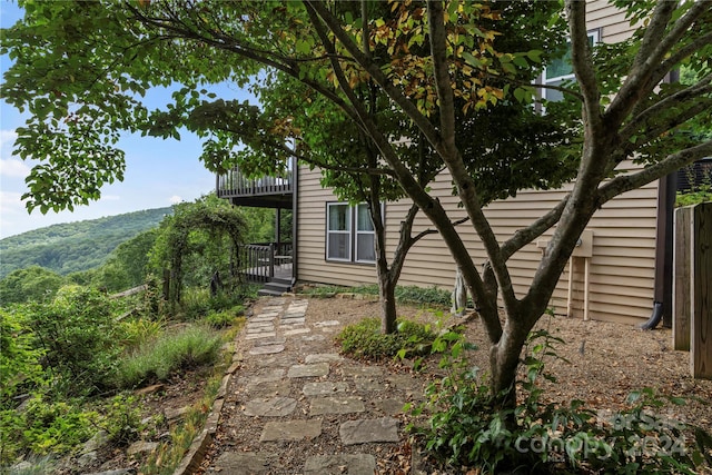 view of side of property featuring a deck with mountain view