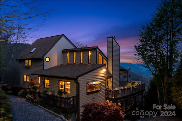 view of back house at dusk