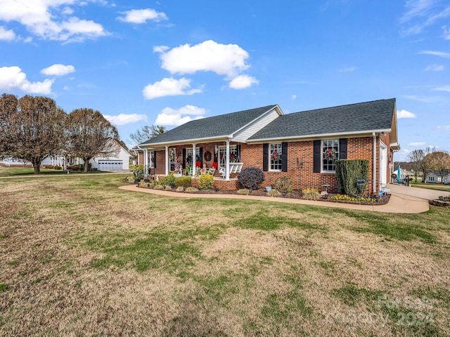 ranch-style home featuring a porch and a front yard