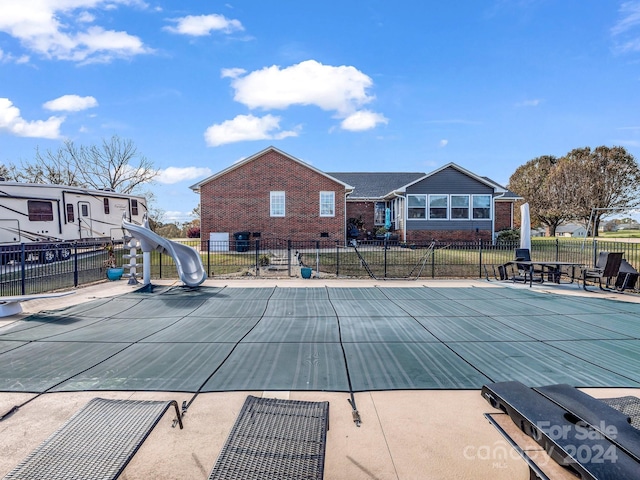 view of pool with a patio area and a water slide