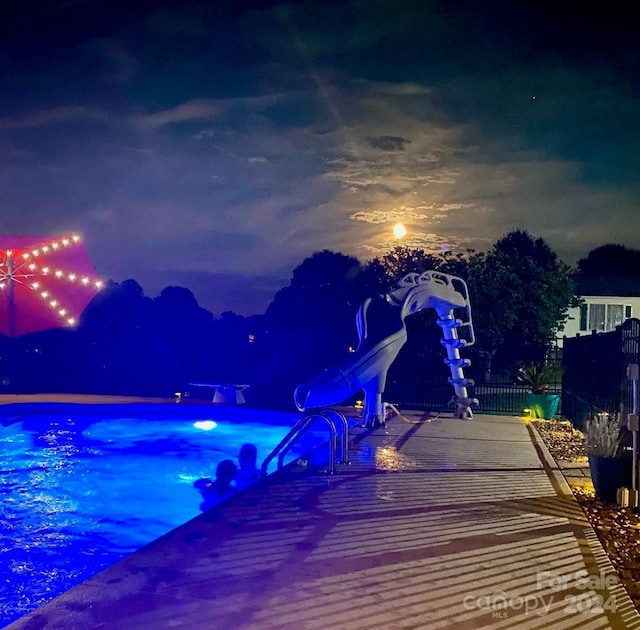 pool at night with a water slide