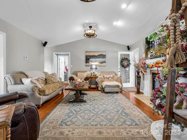 living room with hardwood / wood-style floors and lofted ceiling