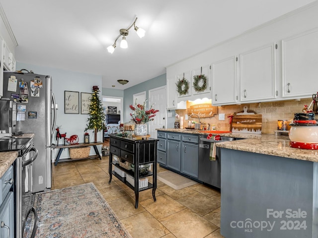 kitchen with backsplash, stainless steel electric stove, sink, white cabinets, and gray cabinets