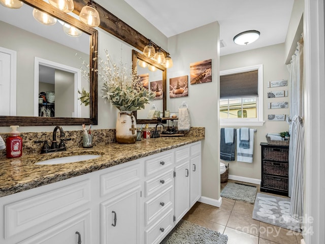 bathroom featuring tile patterned flooring, vanity, and toilet