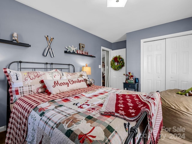 bedroom with hardwood / wood-style flooring and a closet