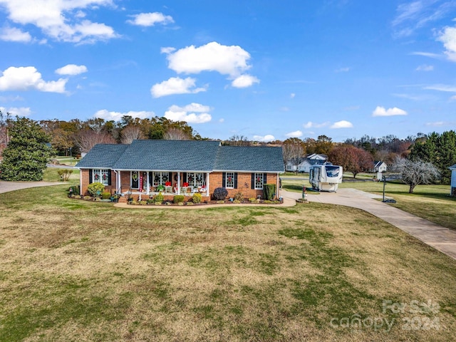 single story home with covered porch and a front lawn