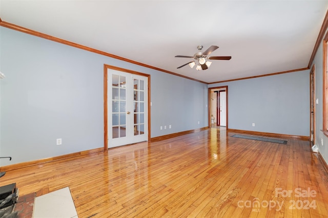 spare room featuring crown molding, ceiling fan, french doors, and light hardwood / wood-style floors