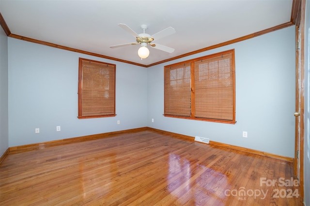 spare room featuring ceiling fan, ornamental molding, and light hardwood / wood-style flooring