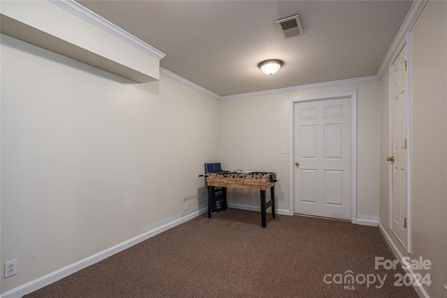 miscellaneous room with dark carpet and crown molding