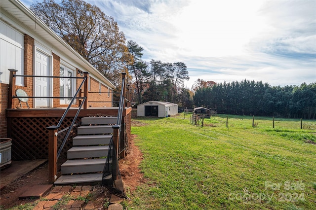 view of yard with a deck and a storage unit