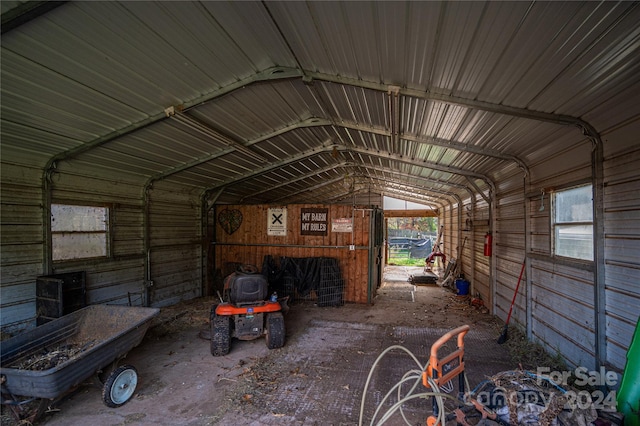 interior space featuring vaulted ceiling and wooden walls