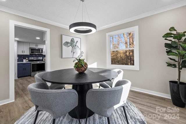 dining room featuring dark hardwood / wood-style flooring and ornamental molding