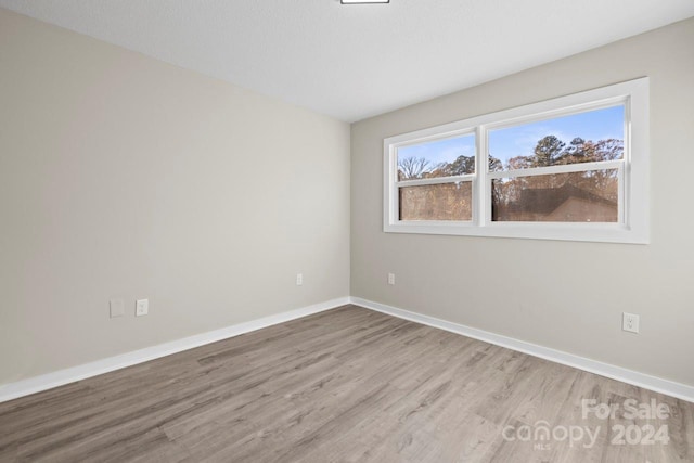 unfurnished room featuring light hardwood / wood-style floors