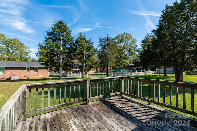 wooden deck featuring a lawn