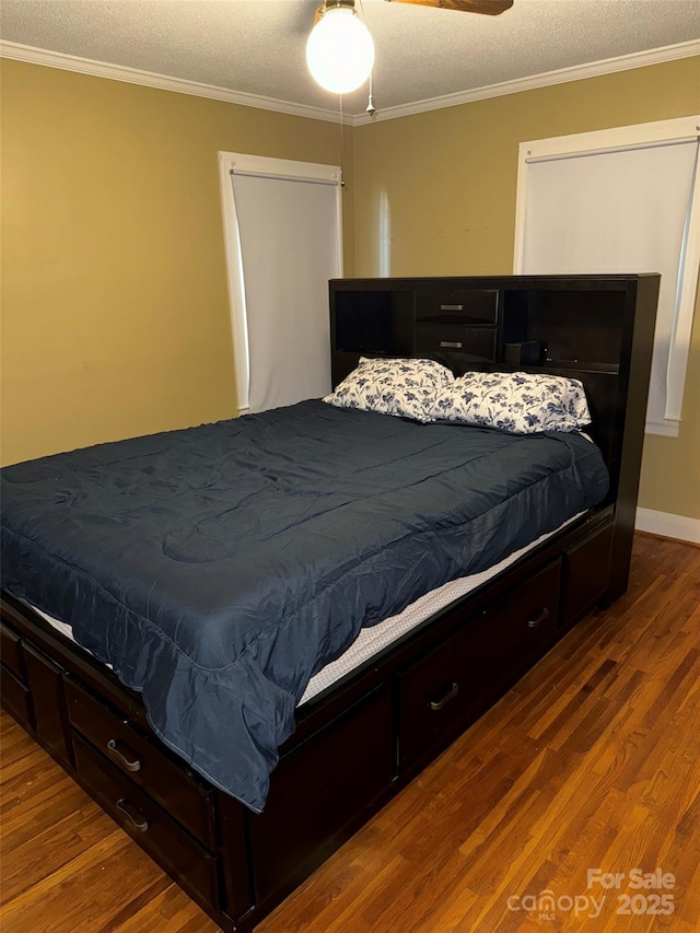 bedroom with ceiling fan, wood-type flooring, a textured ceiling, and ornamental molding