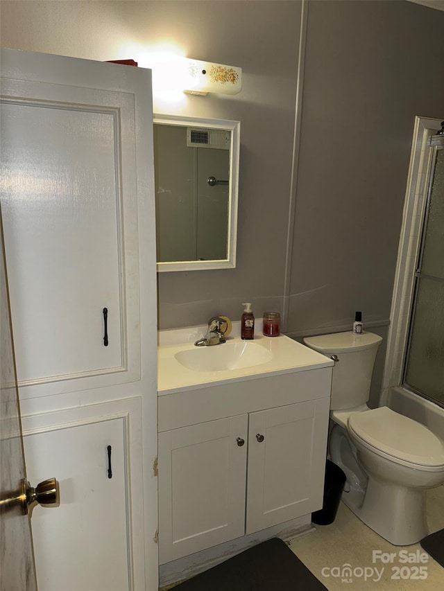 full bathroom featuring tile patterned flooring, vanity, toilet, and bath / shower combo with glass door