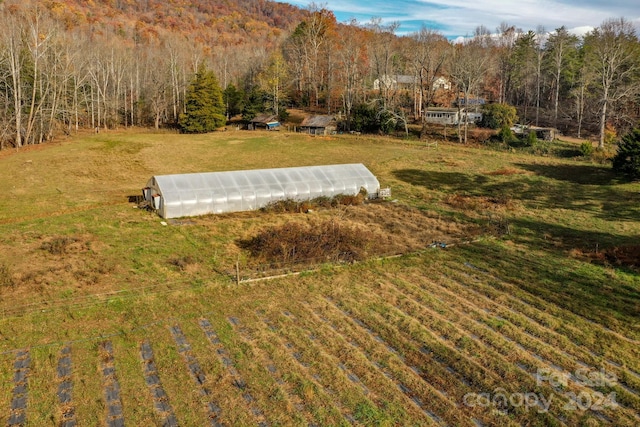 view of yard with a rural view and an outbuilding