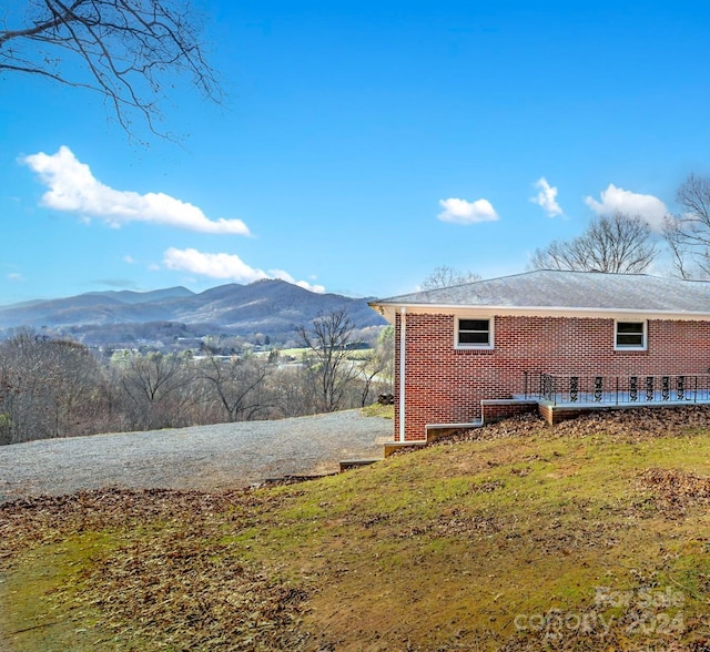 view of side of home featuring a mountain view