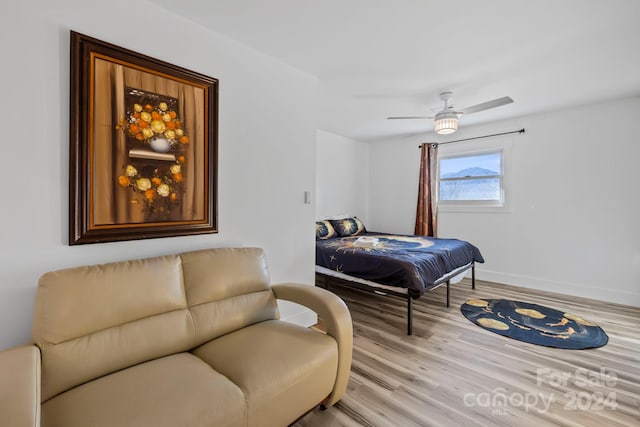 bedroom with ceiling fan and light hardwood / wood-style flooring