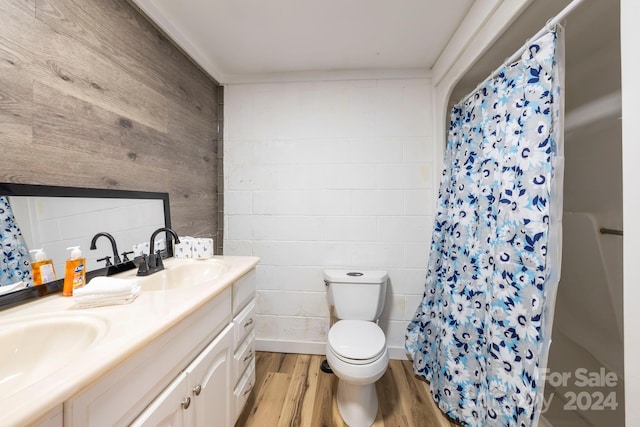 bathroom featuring hardwood / wood-style flooring, vanity, curtained shower, and toilet