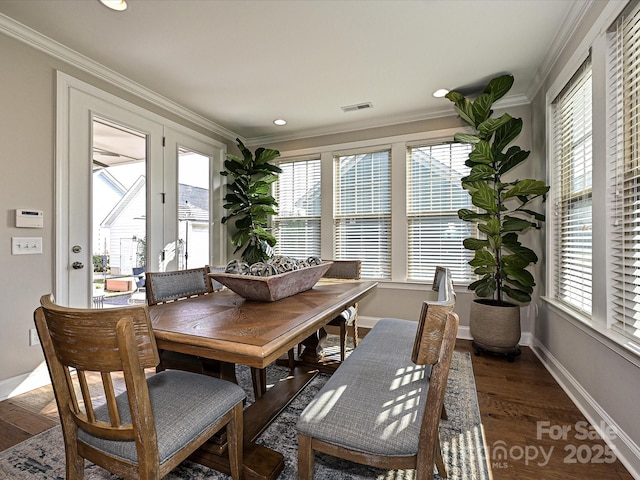 dining space with dark hardwood / wood-style floors and ornamental molding