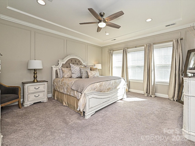 carpeted bedroom featuring ceiling fan and ornamental molding