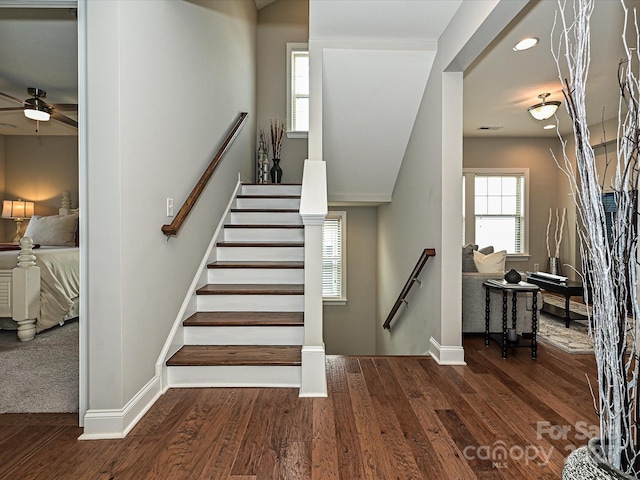 stairway with hardwood / wood-style flooring and ceiling fan