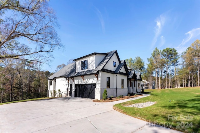 view of property exterior featuring a yard and a garage