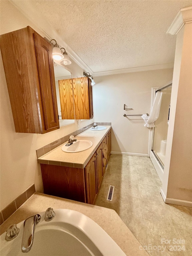 bathroom with vanity, a textured ceiling, and tile patterned flooring