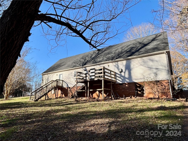 back of house featuring a yard and a deck