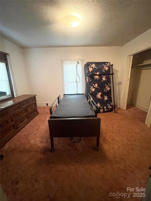 recreation room featuring carpet floors and a textured ceiling