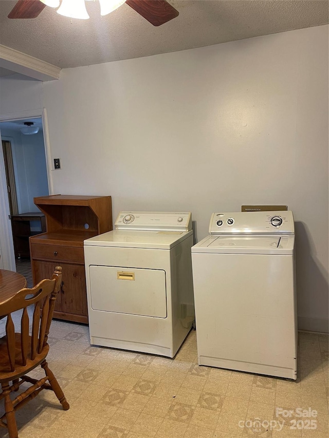 clothes washing area with light floors, ceiling fan, washer and clothes dryer, and a textured ceiling