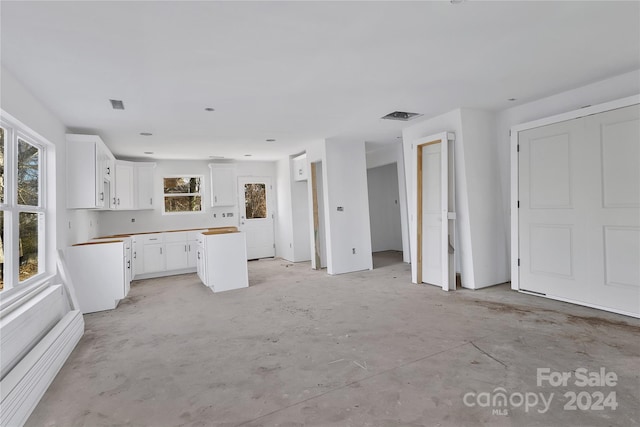 kitchen featuring white cabinetry and wood counters