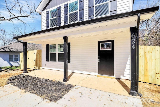 entrance to property featuring fence