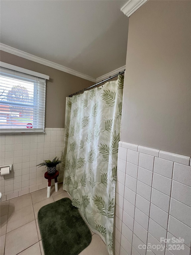 bathroom with tile patterned floors, tile walls, and crown molding