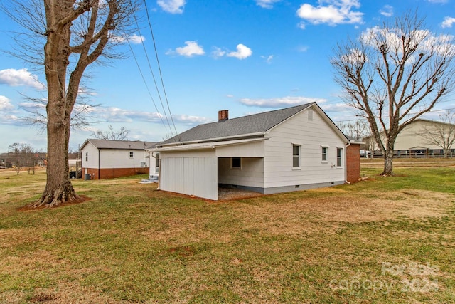 view of side of home featuring a yard